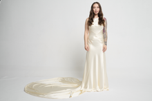 A bias silk crepe back satin gown, with a Cowl Cap from shoulder to Waist.