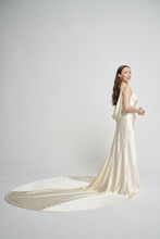 A bias silk crepe back satin gown, with a Cowl Cap from shoulder to Waist.