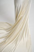 A bias silk crepe back satin gown, with a Cowl Cap from shoulder to Waist.